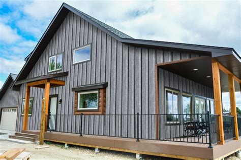 ranch house with gray siding & charcoal metal roofing|ranch house siding ideas.